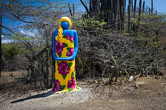 Colorful Sculpture of Woman in Floral Dress in Desert