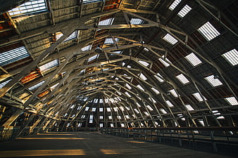 Interior of historic wooden dockyard building with arched roof