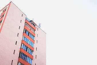 Low angle view of modern apartment building with orange accents