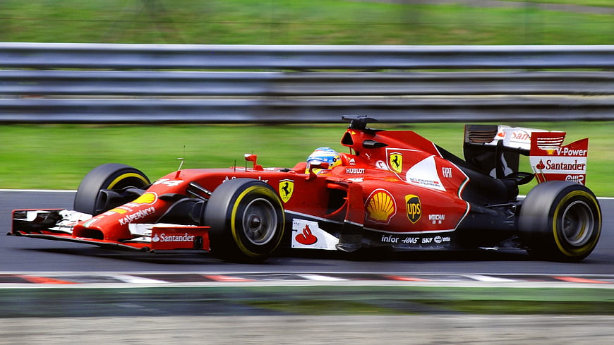 Red Ferrari Formula 1 Race Car Speeding on Track