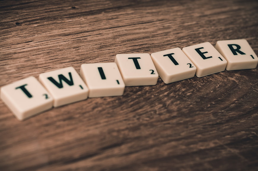 Twitter spelled with Scrabble tiles on wooden background