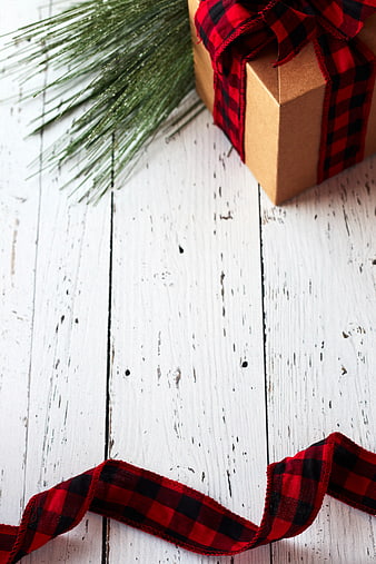 Rustic Christmas Gift Box with Plaid Ribbon on White Wood