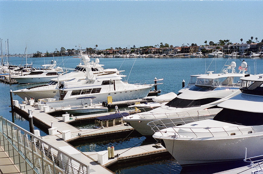 Luxury white yachts docked in sunny marina harbor