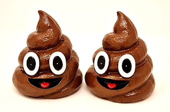 Two glossy brown ceramic poop emoji figurines with smiling faces