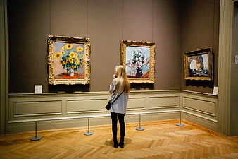 Woman Viewing Van Gogh Sunflowers in Museum Gallery