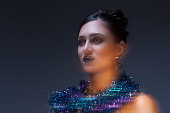 Woman with Glowing Blue Tinsel and Neon Light Trails