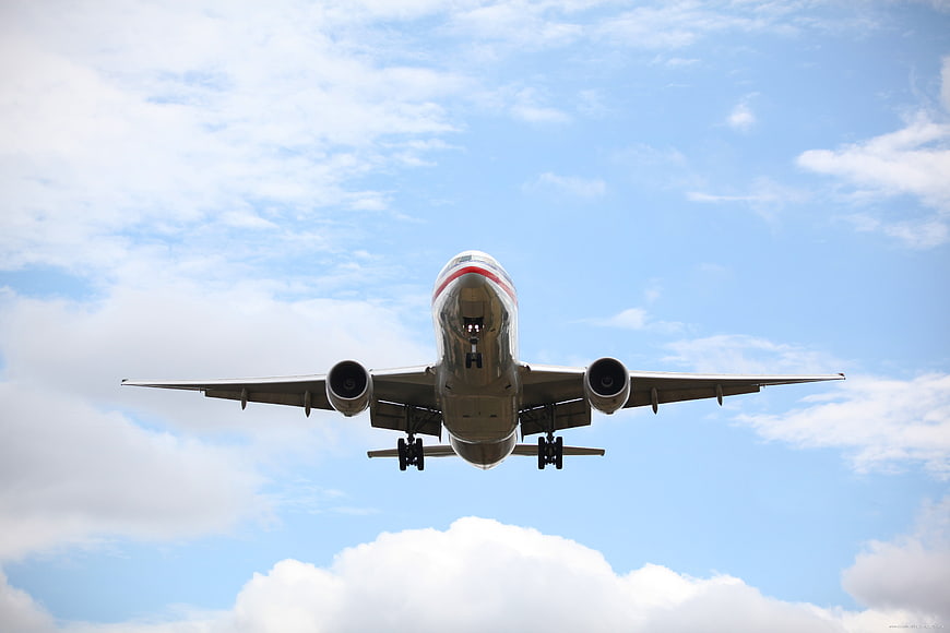 Commercial Jet Airplane Approaching For Landing Against Blue Sky