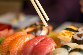 Close-up of fresh sushi platter with chopsticks