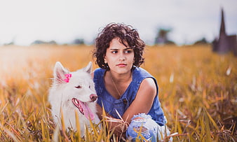 Young Woman with White Dog in Golden Field