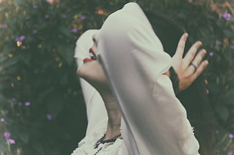 Woman in White Hoodie with Red Lips in Garden