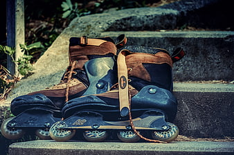 Vintage Brown Inline Skates Resting On Concrete Steps