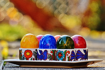 Colorful Easter Eggs in Traditional Ceramic Holders
