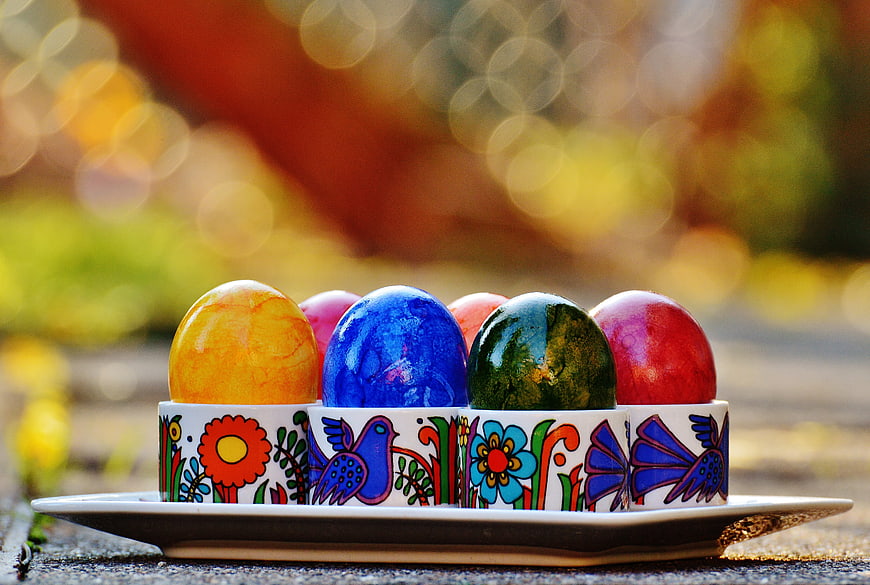 Colorful Easter Eggs in Traditional Ceramic Holders
