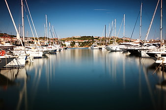 Serene Marina with Sailboats and Calm Water Reflections