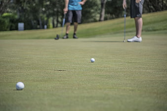 Golfers Putting on Green Course with Golf Balls