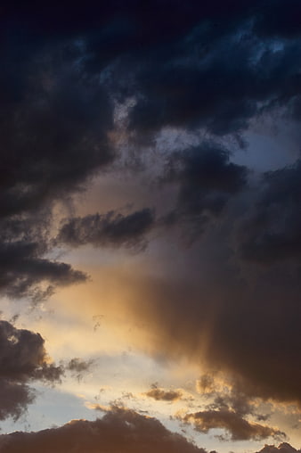 Dramatic Stormy Sky with Golden Sun Rays at Dusk