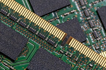 Macro shot of green computer RAM memory module circuit board