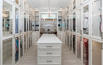 Luxurious White Walk-In Closet With Central Island And Glass Cabinets