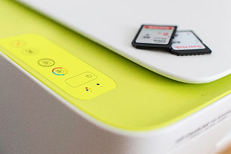 Close-up of lime green printer with memory cards