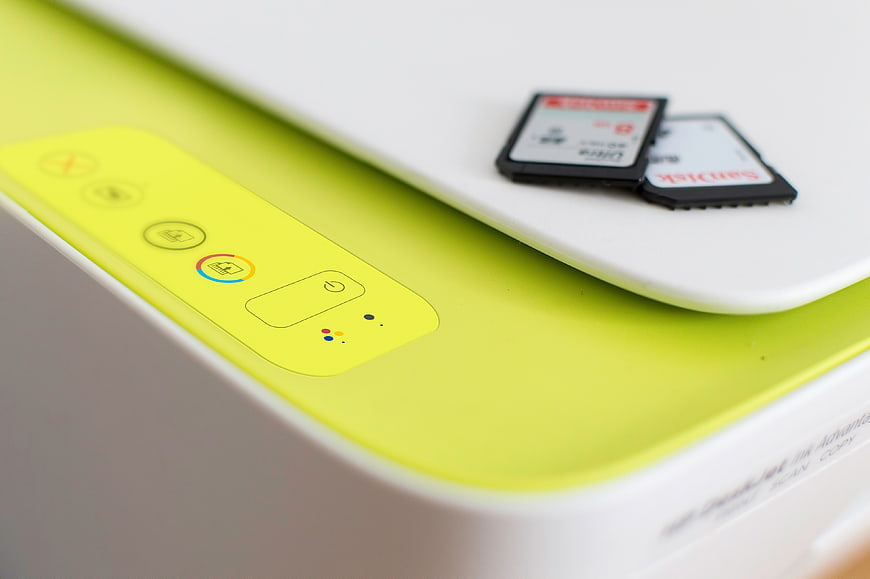 Close-up of lime green printer with memory cards