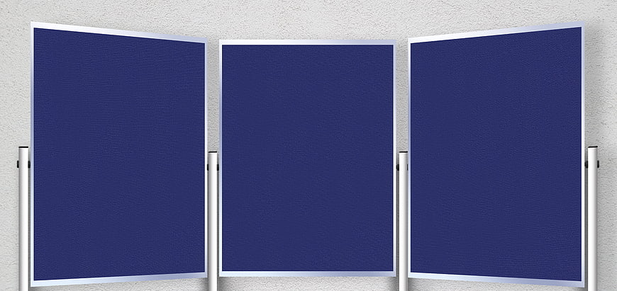 Three empty blue presentation boards on metal stands against a textured wall