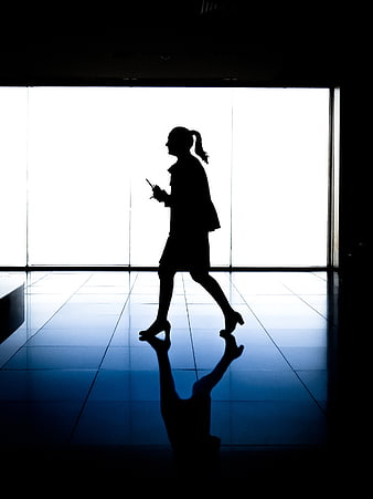 Silhouette of Business Woman Walking in Office