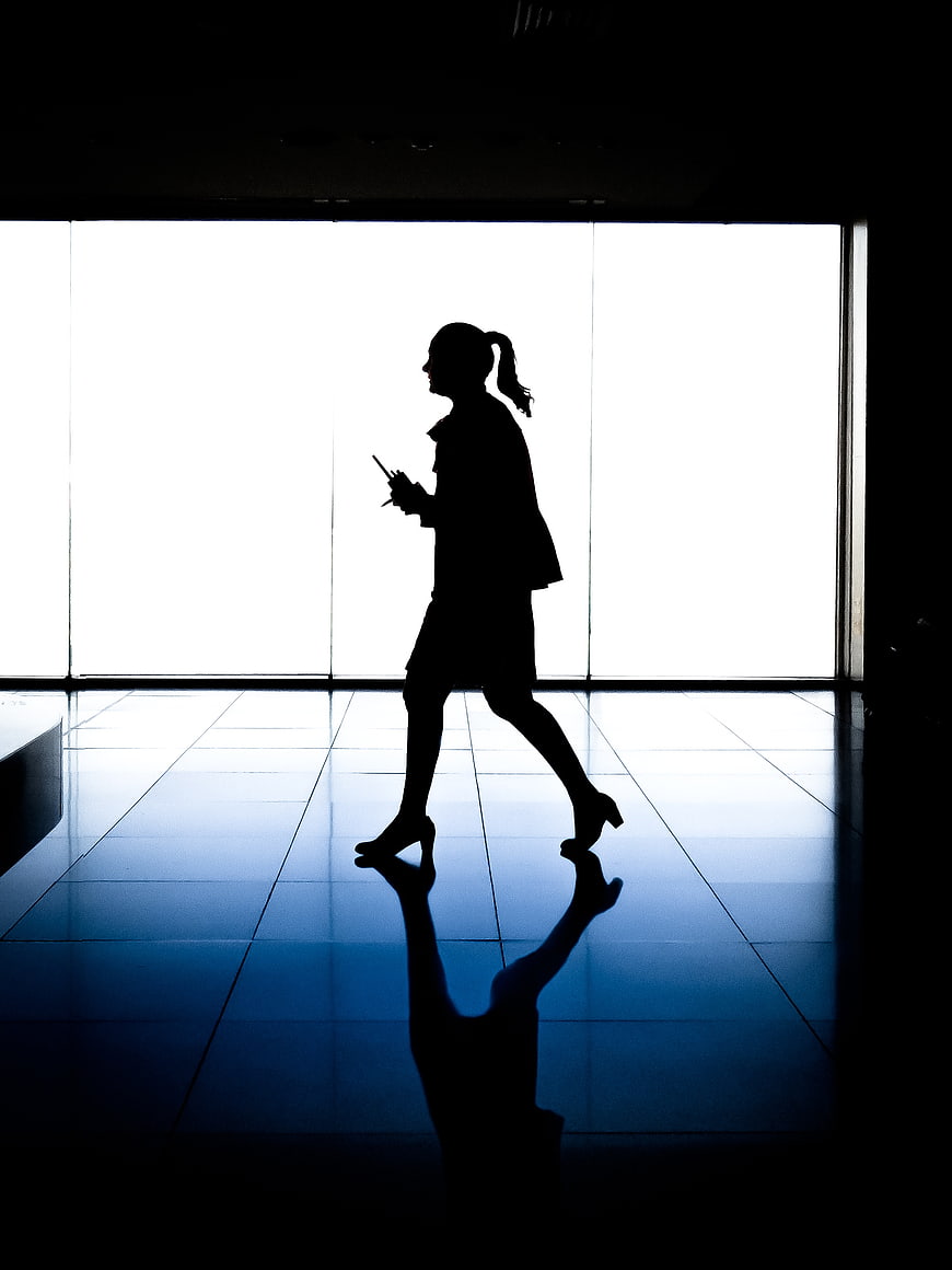 Silhouette of Business Woman Walking in Office