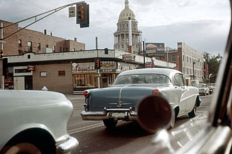 Vintage 1950s Street Scene with Classic Cars and City Hall
