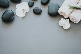 Spa Wellness Background with Stones, Orchids, and Towels