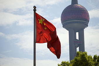 Chinese National Flag Waving In Front Of Shanghai Oriental Pearl Tower