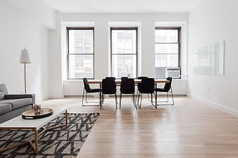Modern minimalist apartment interior with dining table and living area