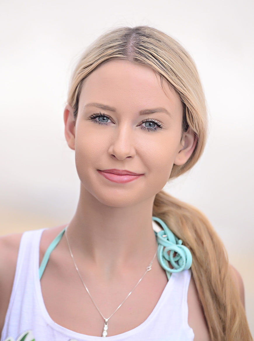Portrait of a smiling young blonde woman with blue eyes