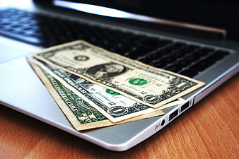 US Dollar Bills on Laptop Keyboard for Online Finance