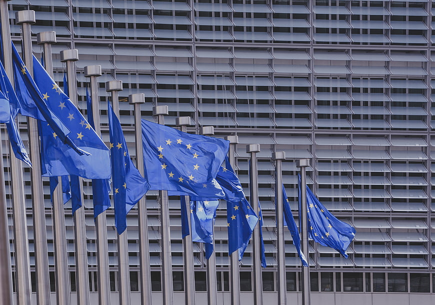 European Union flags waving in front of modern building