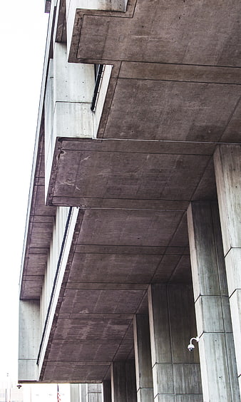 Low angle view of brutalist concrete architecture with geometric beams