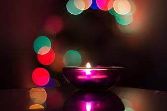 Purple Candle Flame With Festive Bokeh Lights