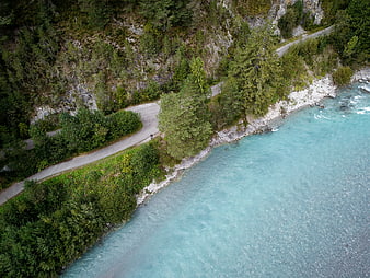 Aerial View of Turquoise River and Winding Mountain Road