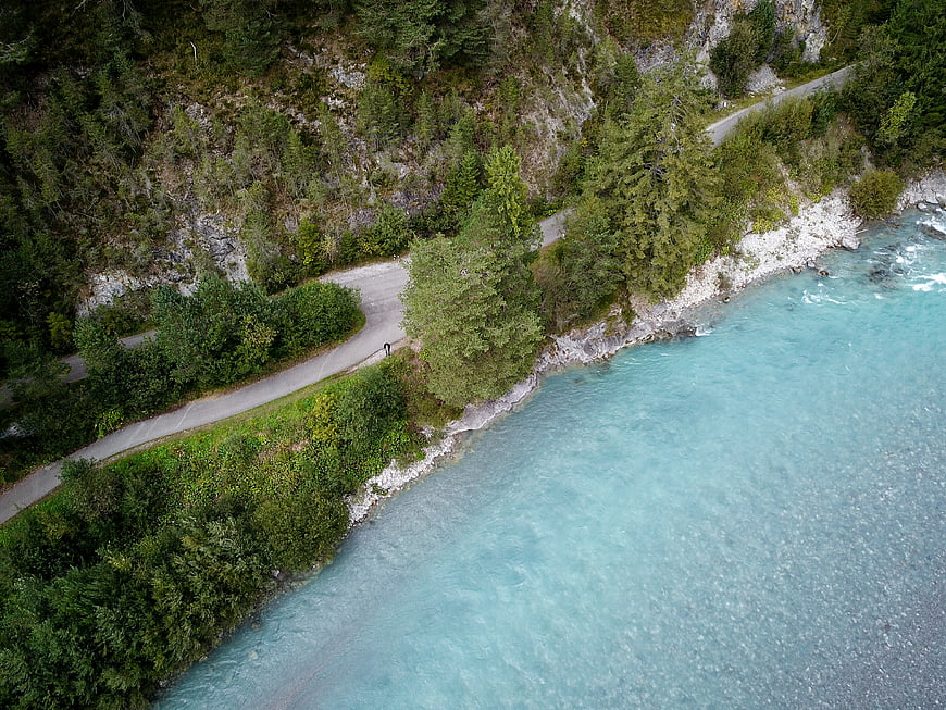 Aerial View of Turquoise River and Winding Mountain Road
