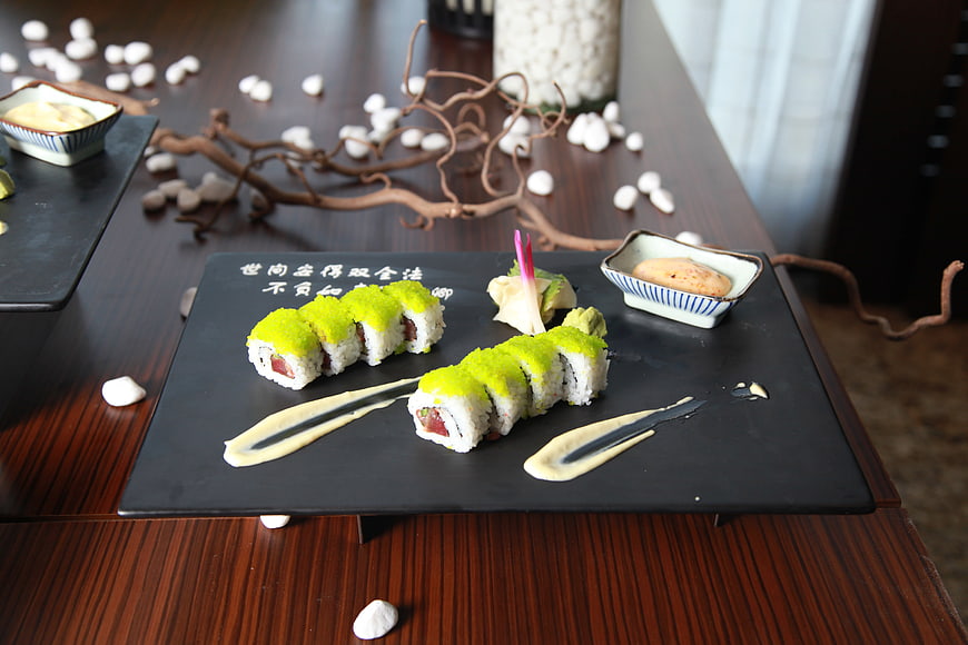Japanese Sushi Rolls on Black Slate with Sauce