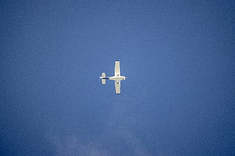 Small Propeller Airplane Flying in Blue Sky
