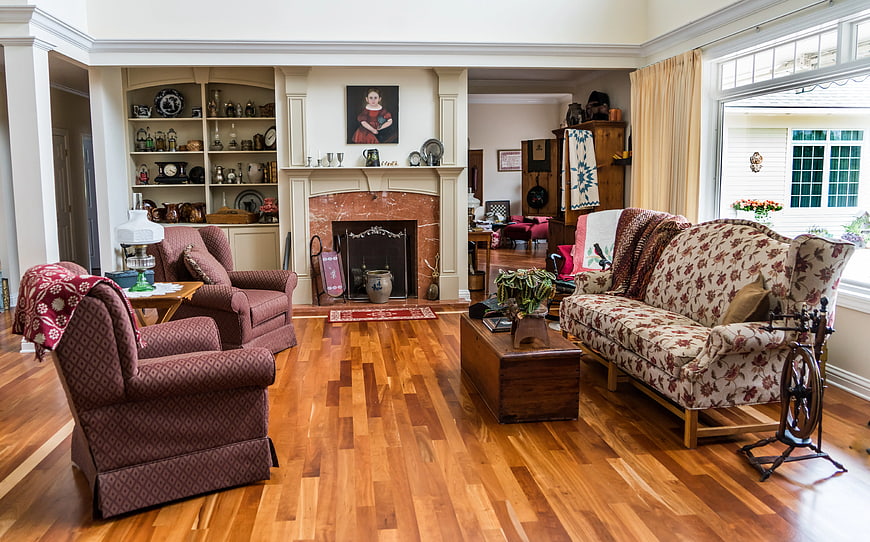 Vintage Living Room with Floral Sofa and Hardwood Floors