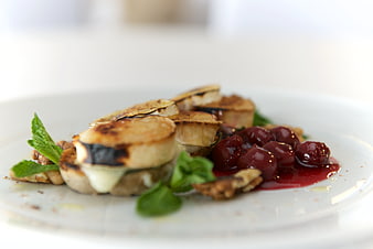 Gourmet Grilled Bananas with Cherries and Mint on White Plate