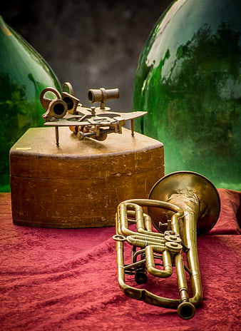 Vintage Brass Trumpet and Sextant on Red Velvet