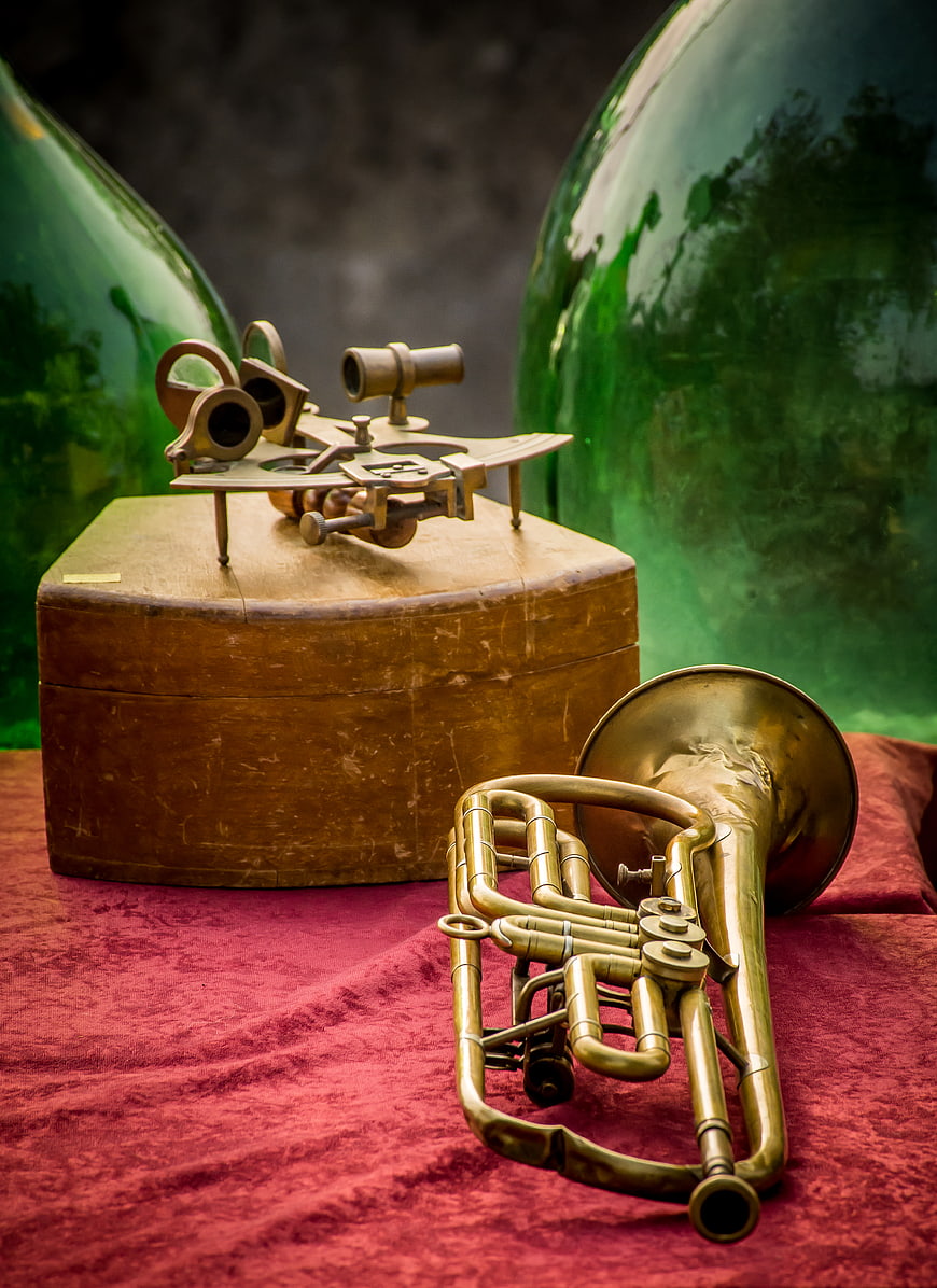 Vintage Brass Trumpet and Sextant on Red Velvet