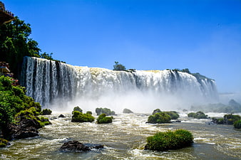Iguazu Falls Waterfall View With Mist And Lush Green Vegetation