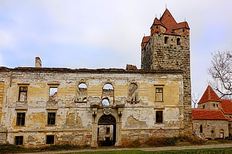 Historic Castle Ruins with Stone Tower and Peeling Facade