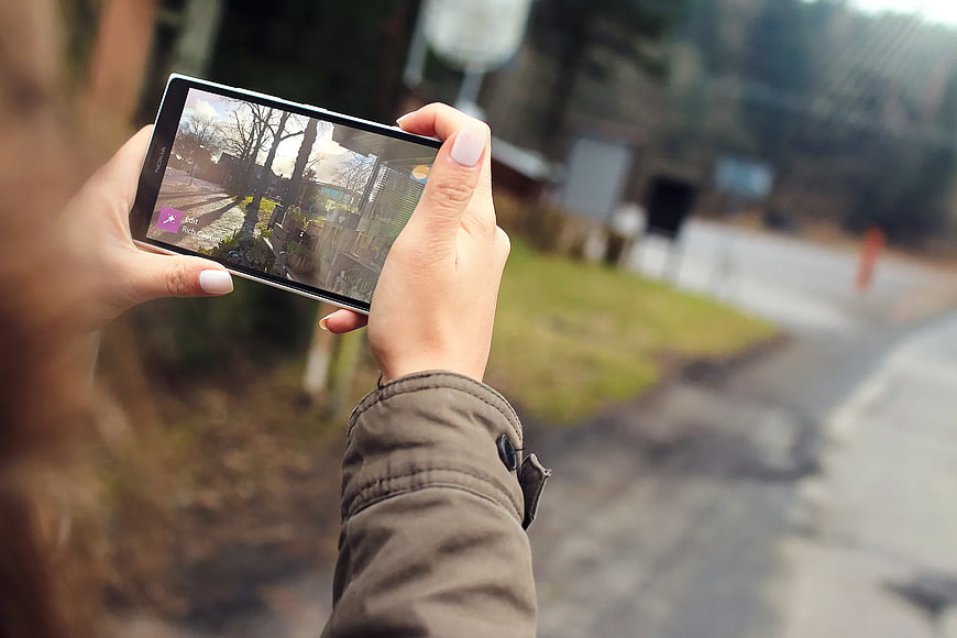 Woman Taking Photo with Smartphone Outdoors