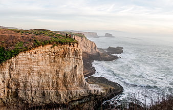 Dramatic Coastal Cliffs with Ocean View and Hikers