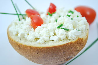 Fresh cottage cheese salad in bread bowl with tomatoes