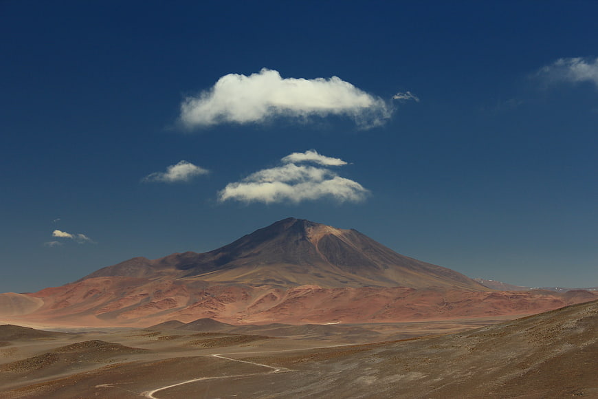 Volcanic Mountain Landscape with Blue Sky and Clouds
